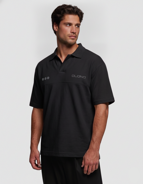 Man wearing a black polo shirt with a brand logo on a white background